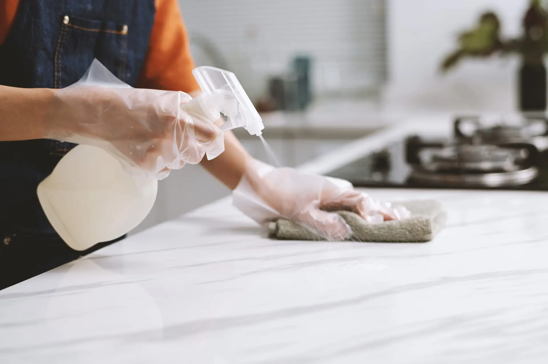 An Urgent Pro bond cleaning provider in Brisbane scrubbing the full kitchen of a Brisbane rental to meet the bond cleaning standard required for a full bond refund, with professional equipment visible in a realistic local service setting