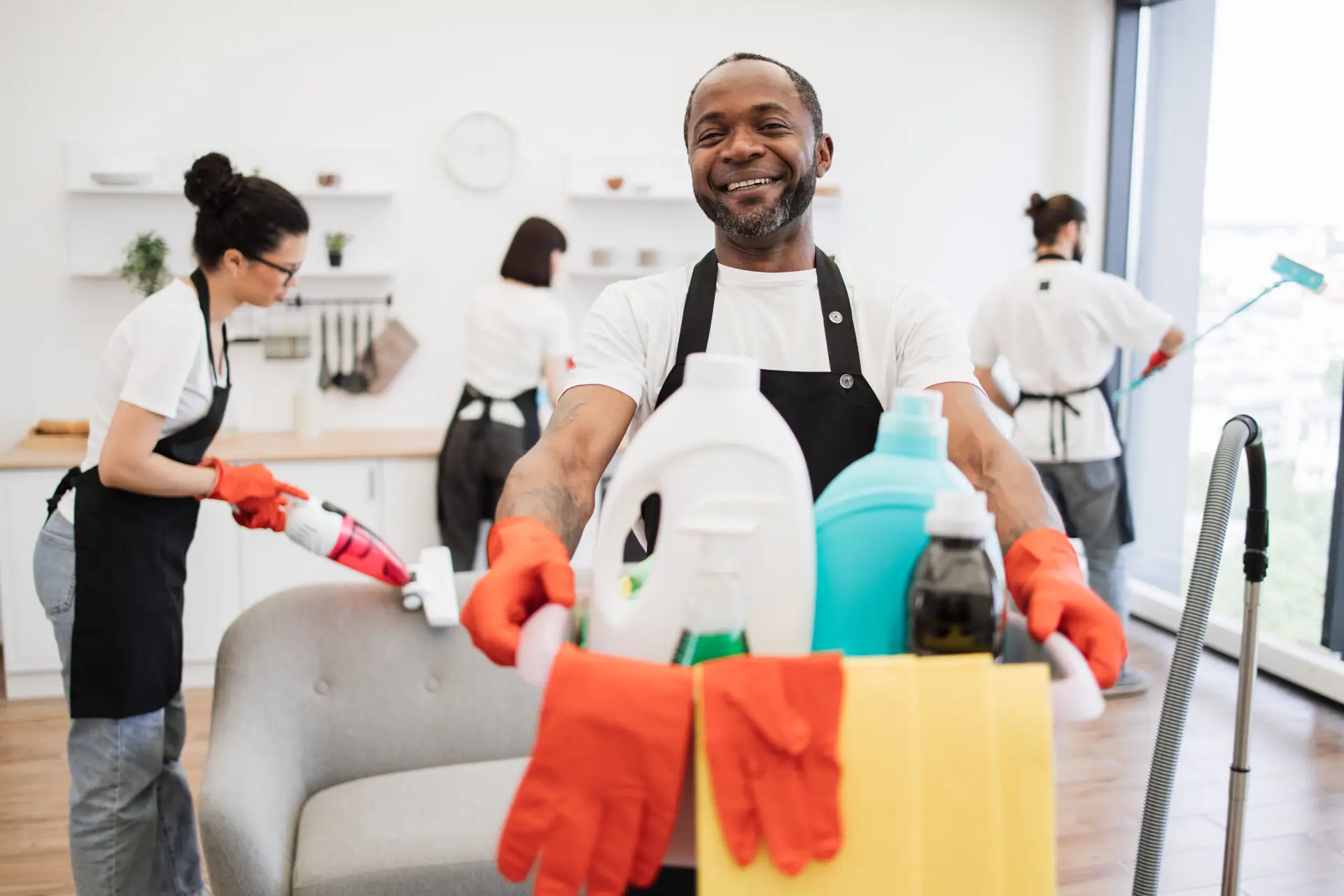An Urgent Pro bond cleaning provider in Brisbane organising supplies and discussing the room order for a bond cleaning job at a Brisbane rental before starting, with professional equipment visible in a realistic local service setting
