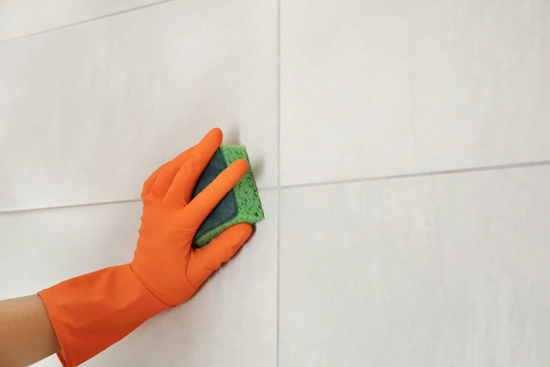 An Urgent Pro bond cleaning provider in Brisbane removing scuff marks from walls and cleaning light switch plates throughout a Brisbane rental, with professional equipment visible in a realistic local service setting
