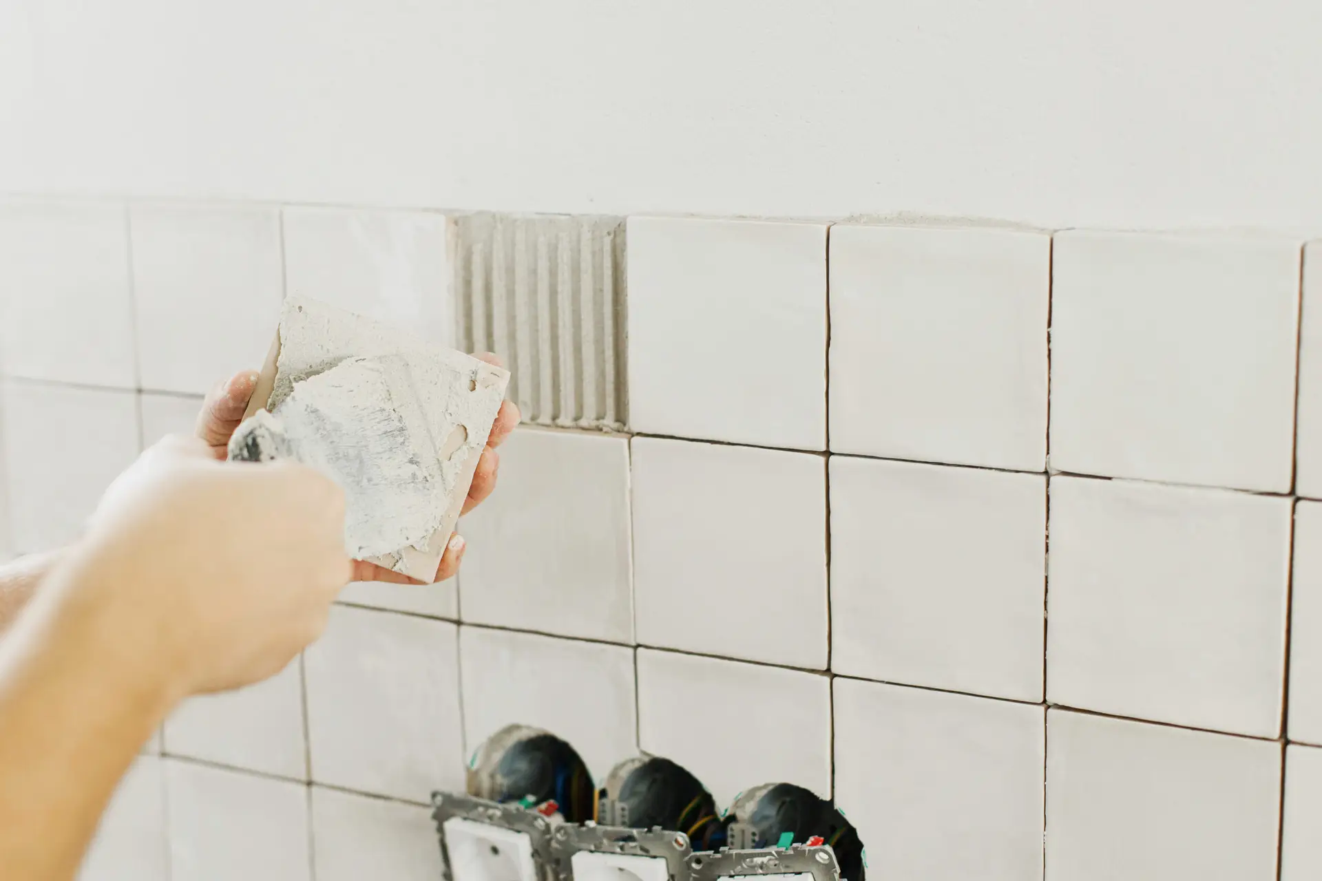 An Urgent Pro bond cleaning provider in Gold Coast polishing tapware, scrubbing the shower and cleaning the toilet in a Gold Coast rental bathroom, with professional equipment visible in a realistic local service setting