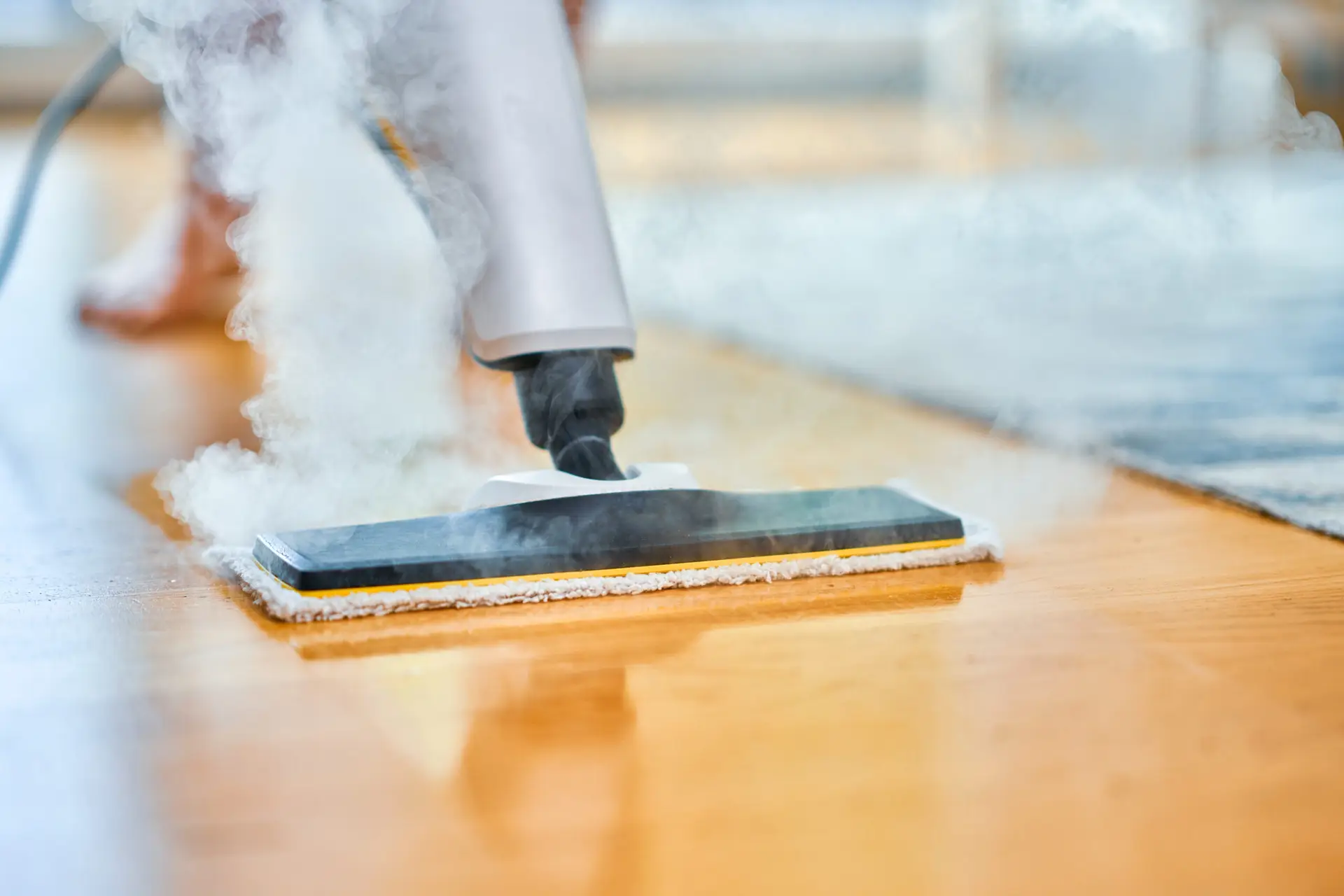 An Urgent Pro carpet cleaning provider in Melbourne cleaning bedroom carpet edges and corners using a detail wand, with professional equipment visible in a realistic local service setting