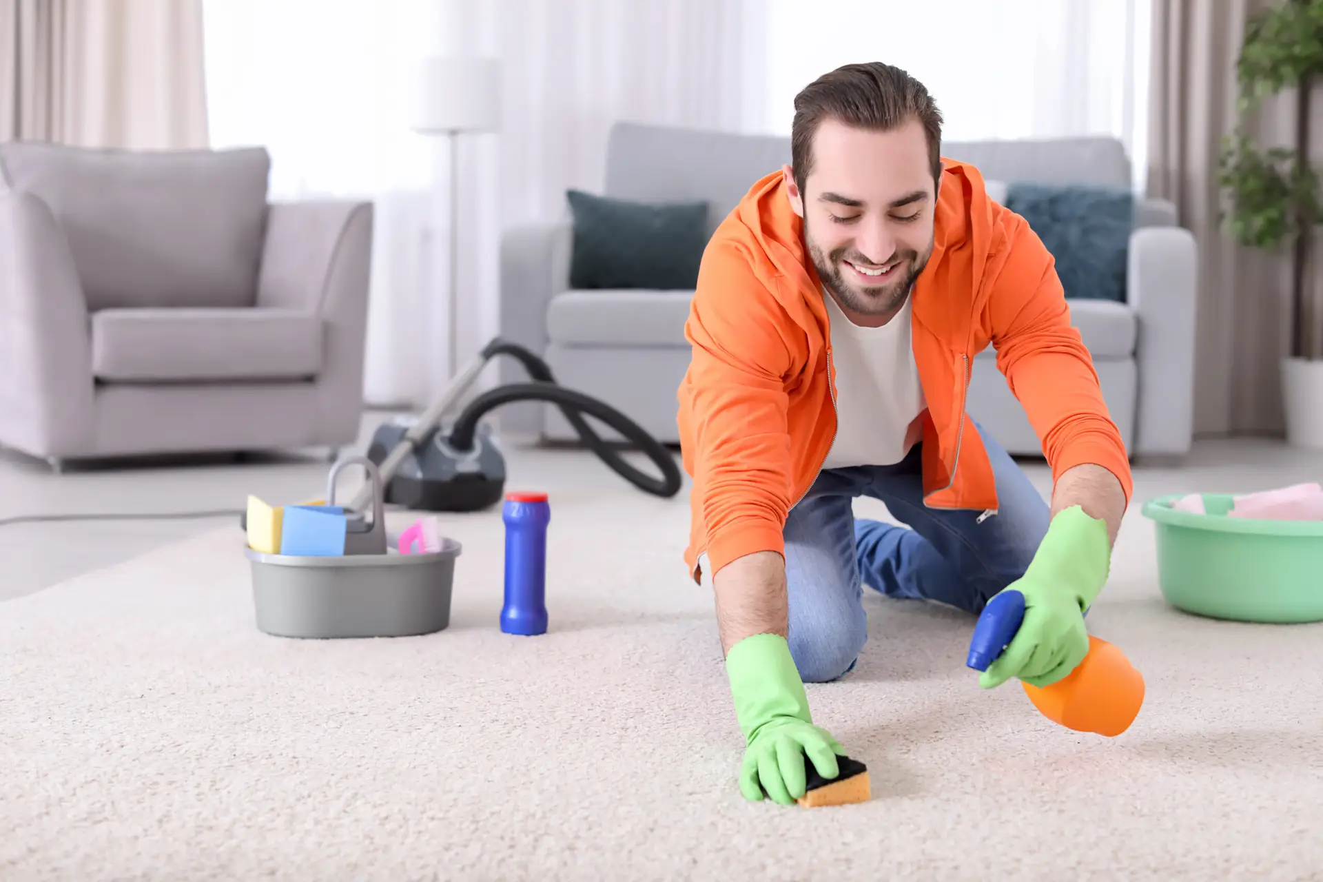 An Urgent Pro carpet cleaning provider in Perth applying a pre-treatment spray to a visible carpet stain before steam cleaning, with professional equipment visible in a realistic local service setting