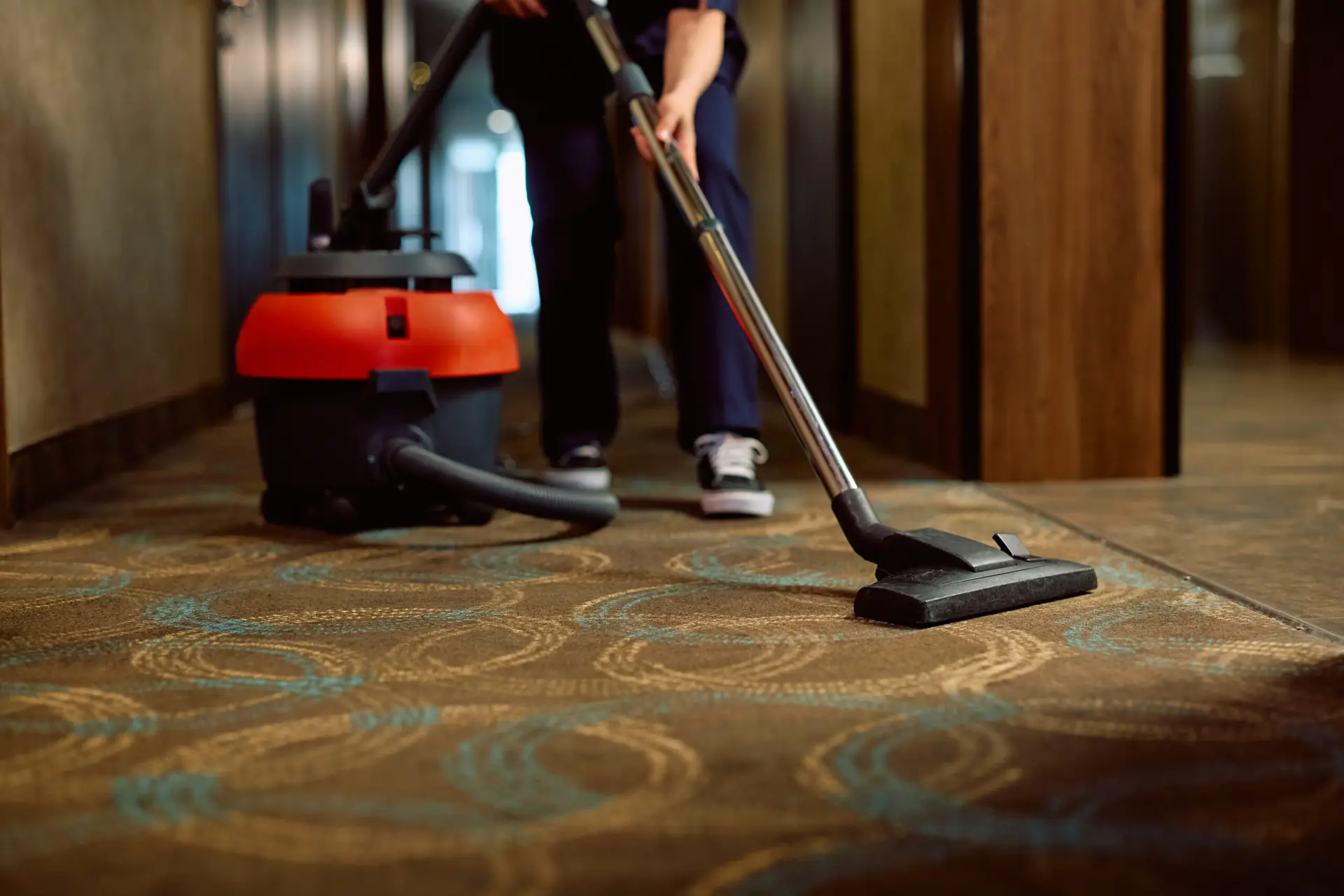 An Urgent Pro carpet cleaning provider in Sydney positioning high-velocity air movers on freshly cleaned carpet to speed drying, with professional equipment visible in a realistic local service setting