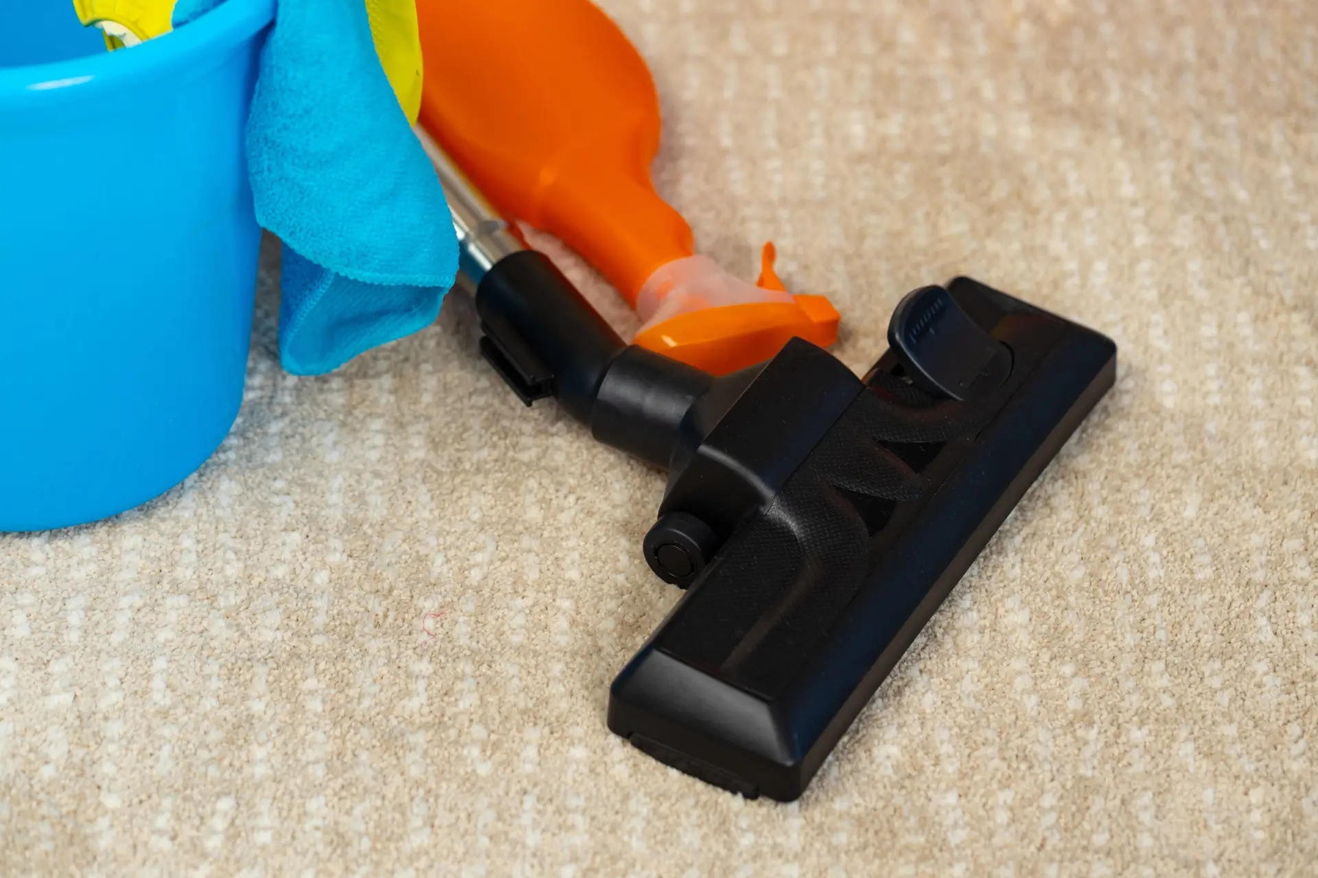 An Urgent Pro carpet cleaning provider in Sydney working methodically in rows across a large carpeted living area, with professional equipment visible in a realistic local service setting