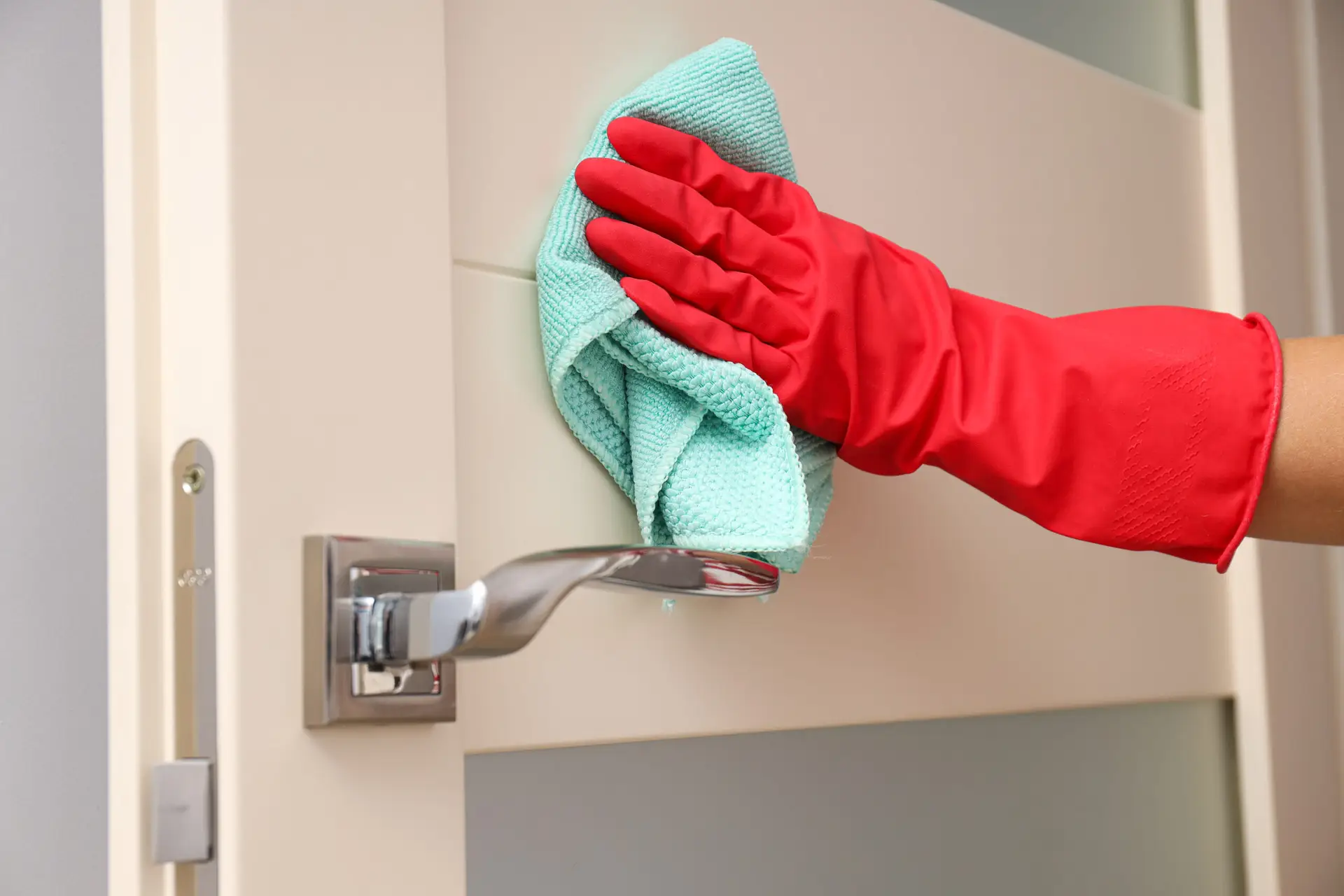 An Urgent Pro end of lease cleaning provider in Melbourne wiping door frames and cleaning fingerprints from painted walls throughout a Melbourne rental, with professional equipment visible in a realistic local service setting