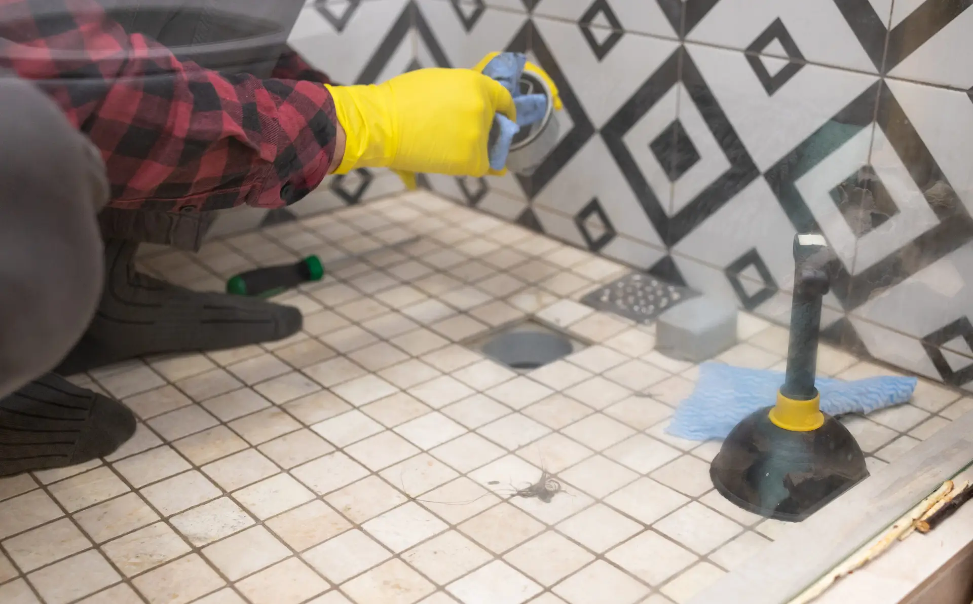 An Urgent Pro end of lease cleaning provider in Melbourne scrubbing shower grout and polishing the tapware in a Melbourne rental bathroom during the end of lease clean, with professional equipment visible in a realistic local service setting