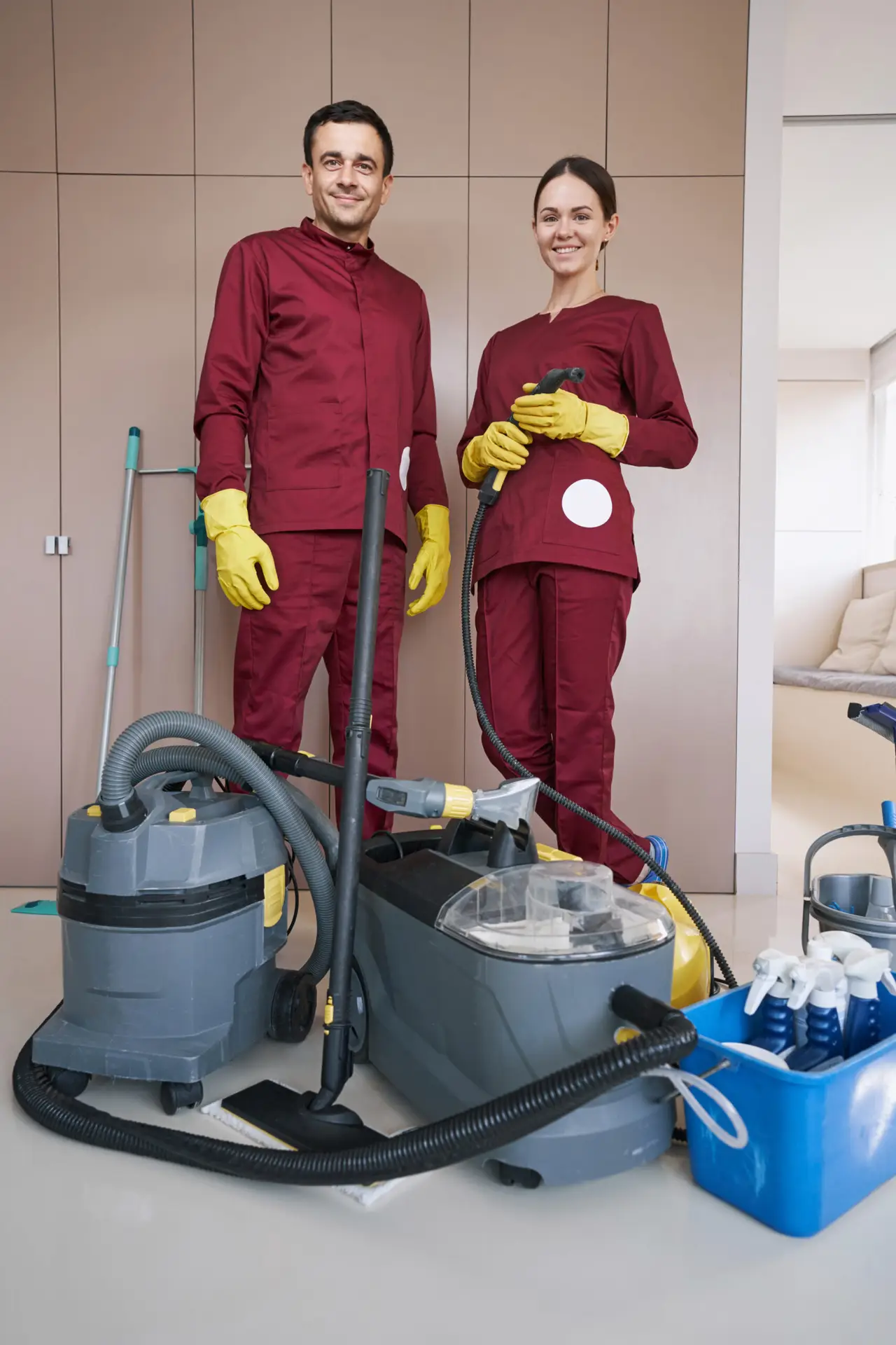 An Urgent Pro end of lease cleaning provider in Perth working in a Perth rental with one cleaner in the kitchen and one vacuuming the main bedroom to complete the job efficiently, with professional equipment visible in a realistic local service setting