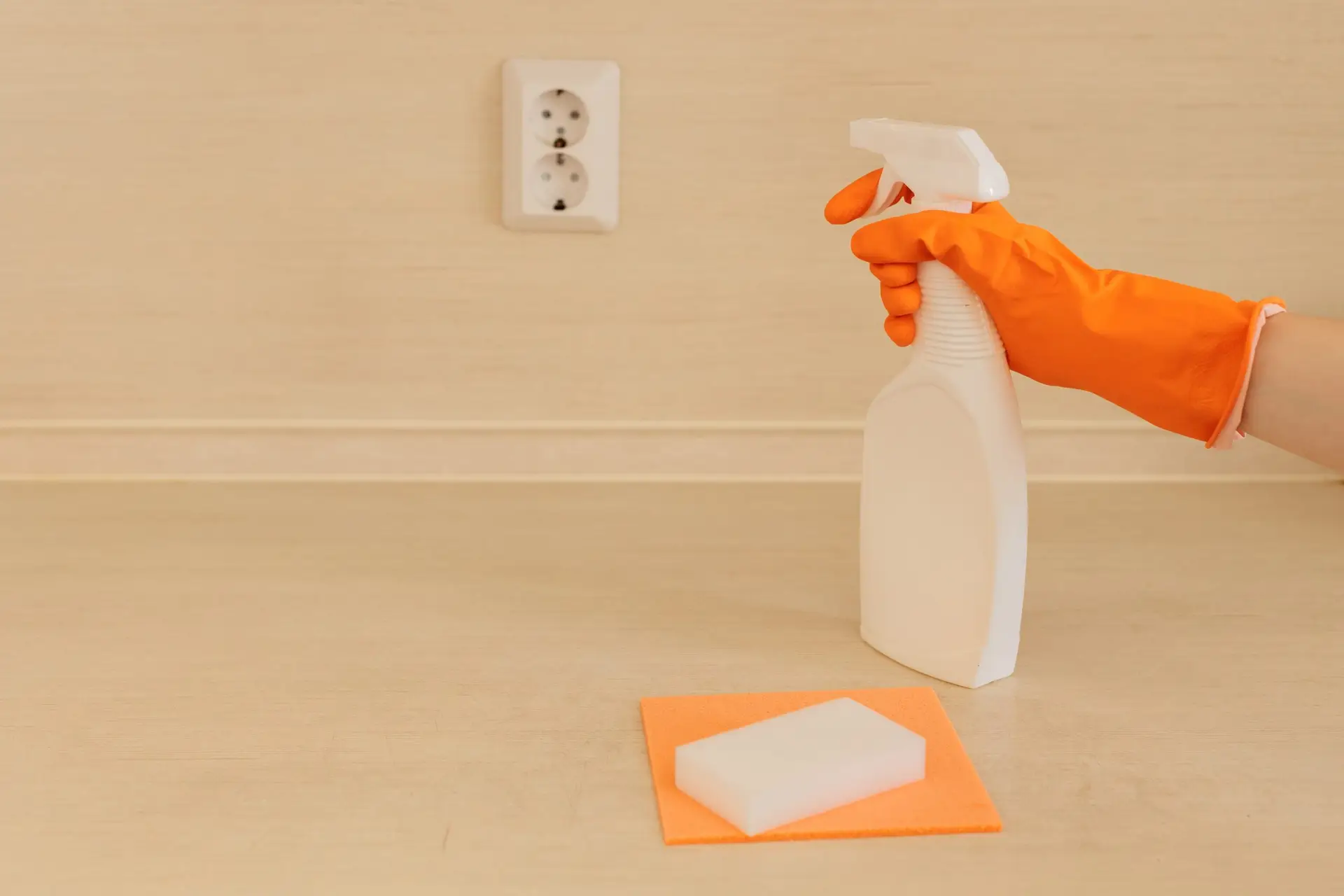 An Urgent Pro end of lease cleaning provider in Perth removing marks from walls and cleaning light switches throughout a Perth rental home during the end of lease service, with professional equipment visible in a realistic local service setting