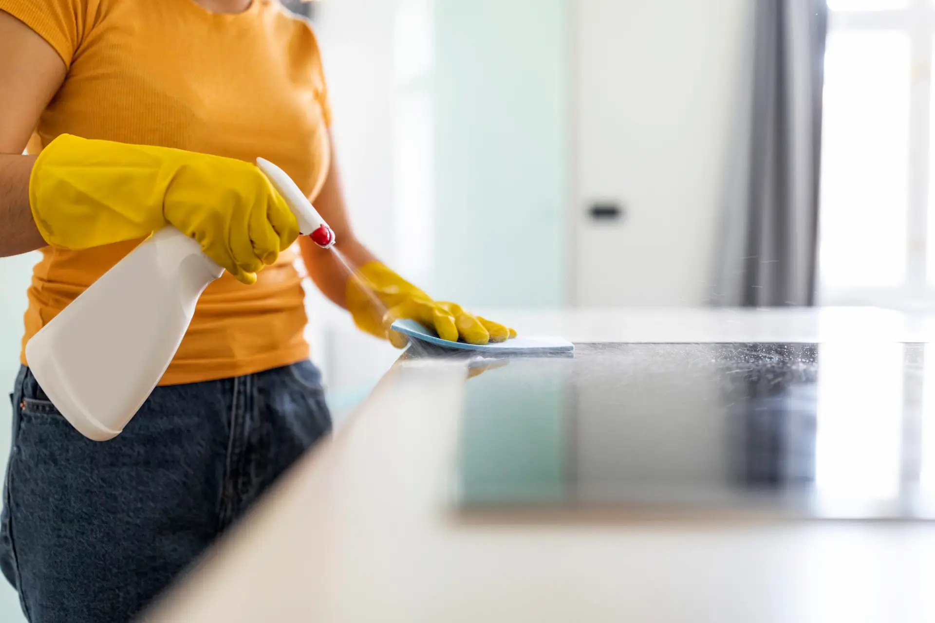 An Urgent Pro end of lease cleaning provider in Sydney thoroughly cleaning every kitchen surface including benchtops, sink, cupboard fronts, splashback and appliances, with professional equipment visible in a realistic local service setting
