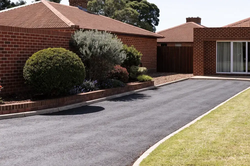 Freshly sealed asphalt driveway beside a brick home, Cannington, Perth