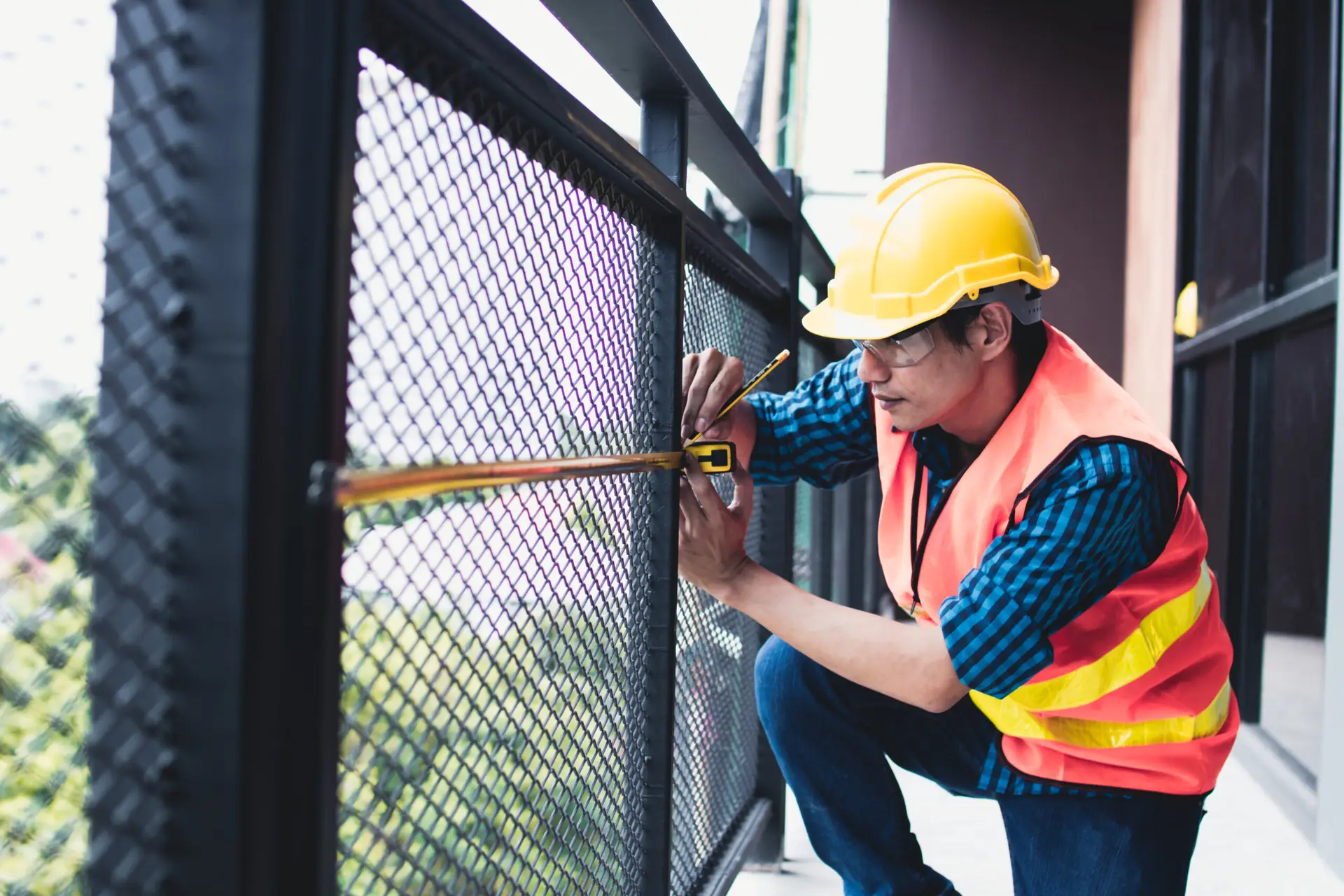 An Urgent Pro handyman provider in Brisbane repairing a damaged fence paling and securing a loose post with a drill and treated timber, with professional equipment visible in a realistic local service setting