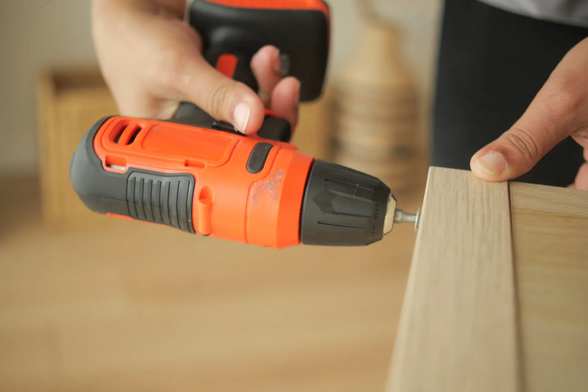 An Urgent Pro handyman provider in Perth measuring, drilling and installing floating wall shelves with a spirit level and wall anchors, with professional equipment visible in a realistic local service setting