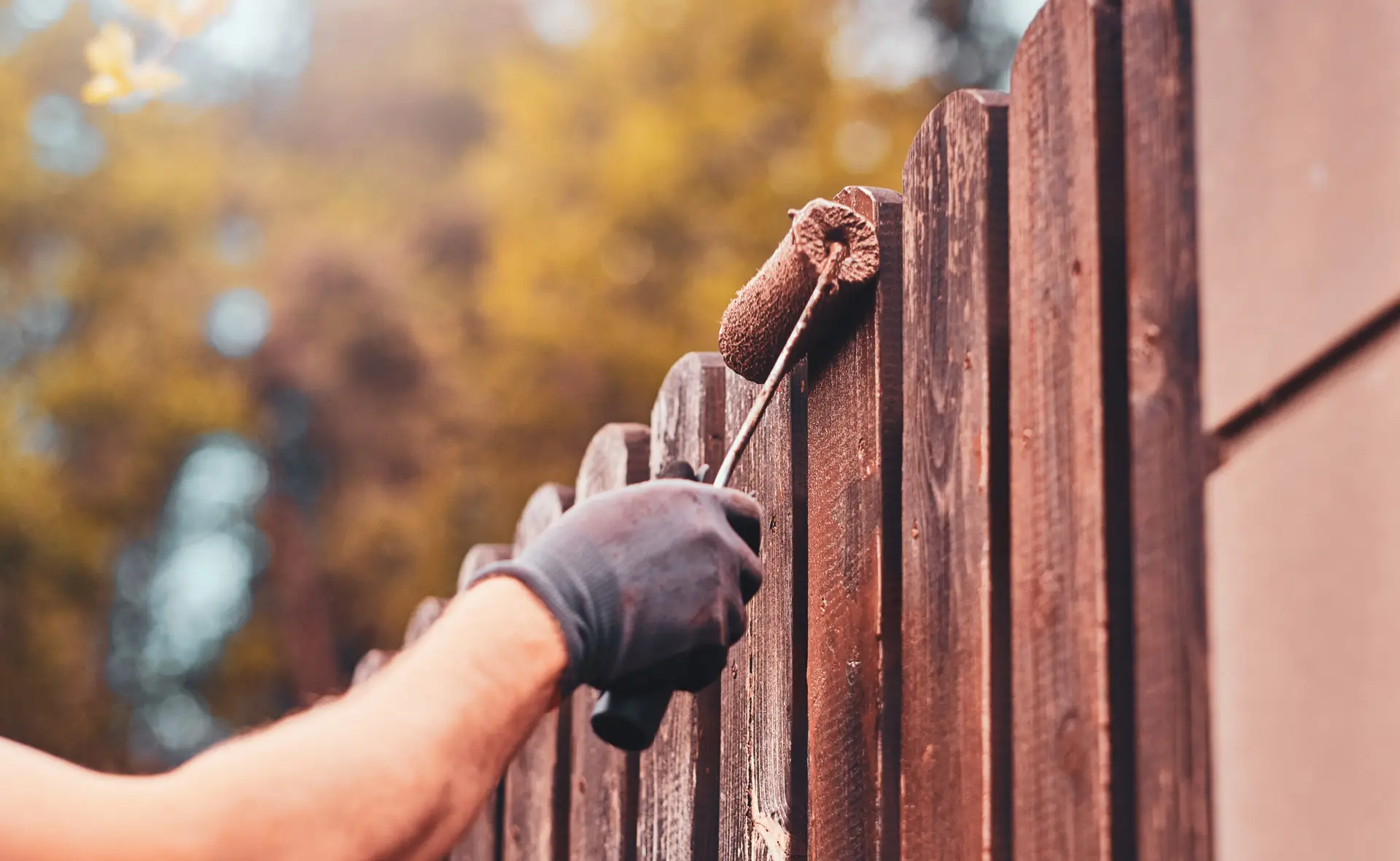 An Urgent Pro handyman provider in Sydney repairing a damaged fence paling and securing a loose post with a drill and treated timber, with professional equipment visible in a realistic local service setting