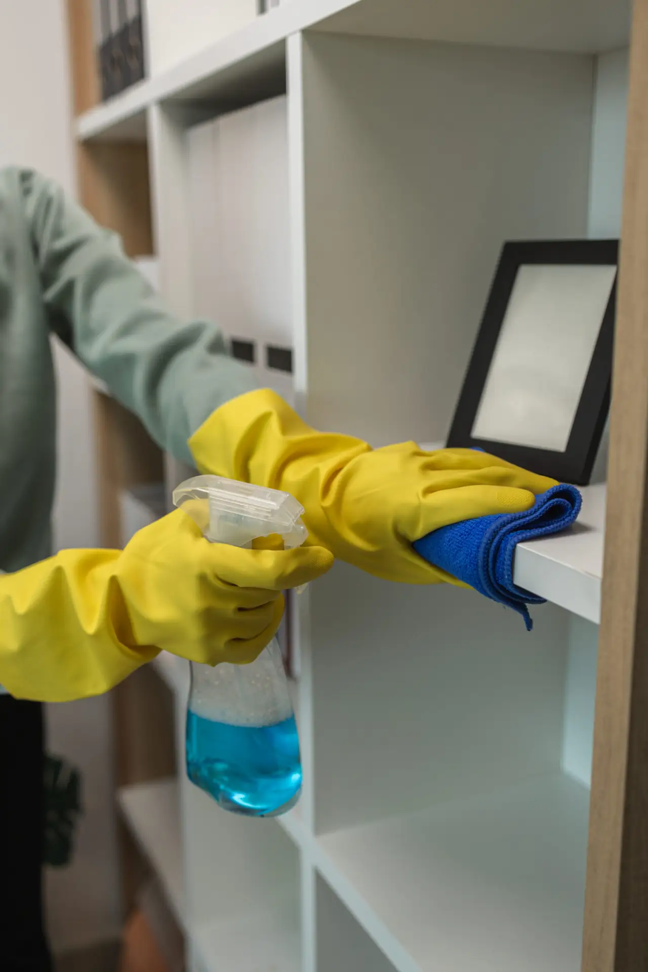 An Urgent Pro house cleaning provider in Perth vacuuming the bedroom floor, dusting the bedside table and wiping window sills in a Perth home bedroom, with professional equipment visible in a realistic local service setting