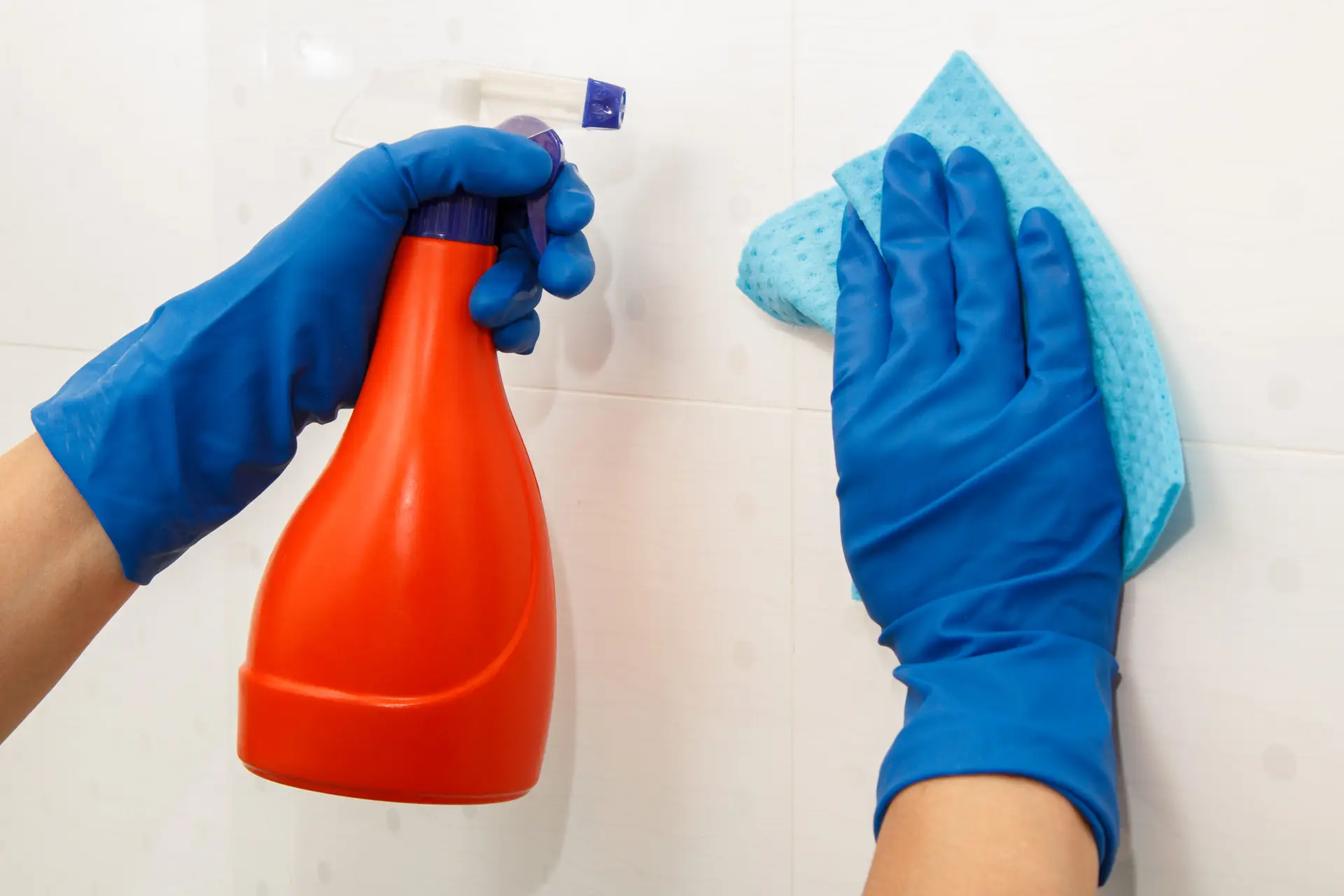 An Urgent Pro house cleaning provider in Sydney scrubbing shower tiles, polishing the vanity mirror and cleaning the toilet in a Sydney home bathroom, with professional equipment visible in a realistic local service setting
