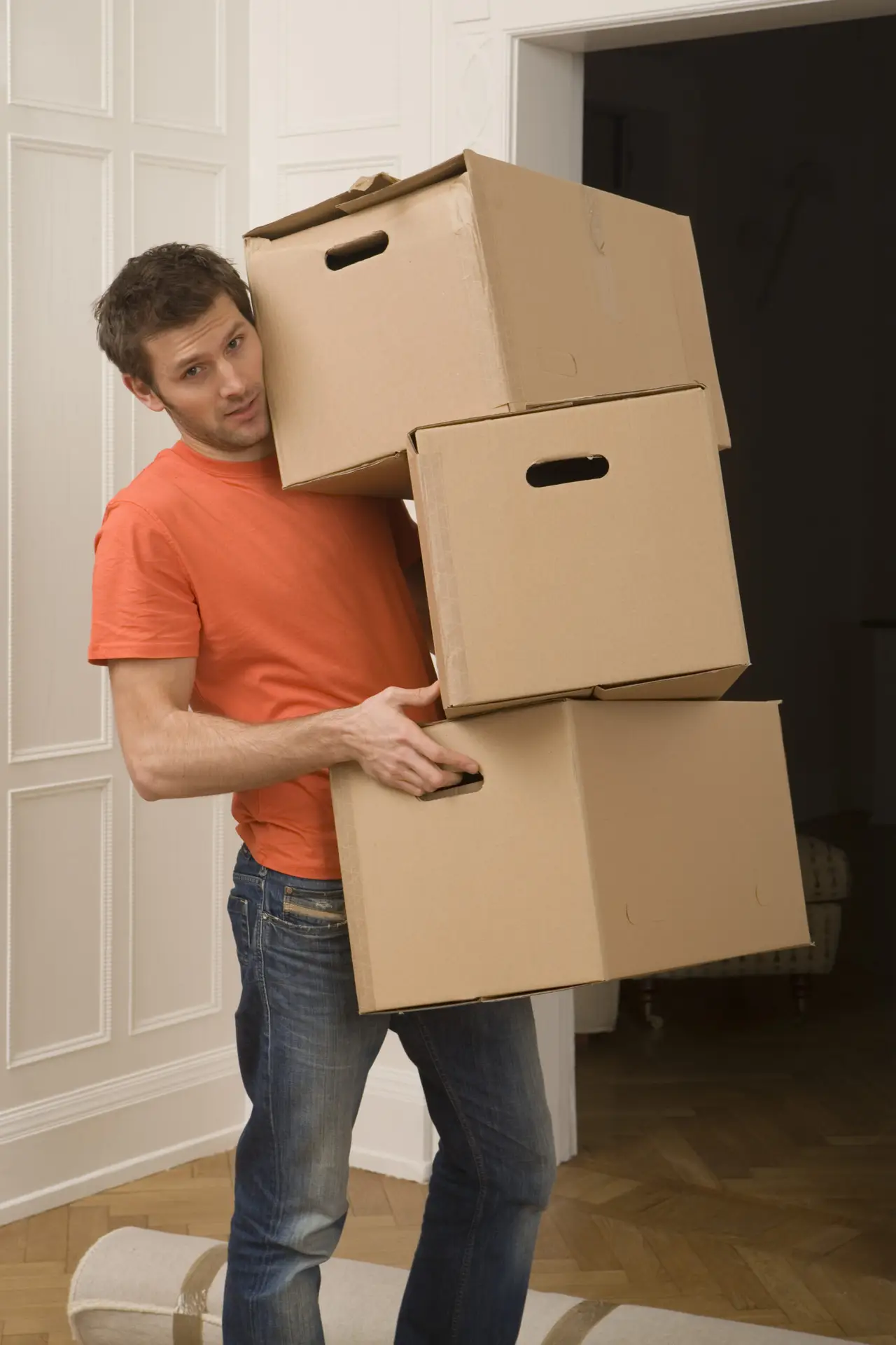 An Urgent Pro house removalists provider in Perth carrying furniture items into a new home through the front door during the delivery stage, with professional equipment visible in a realistic local service setting