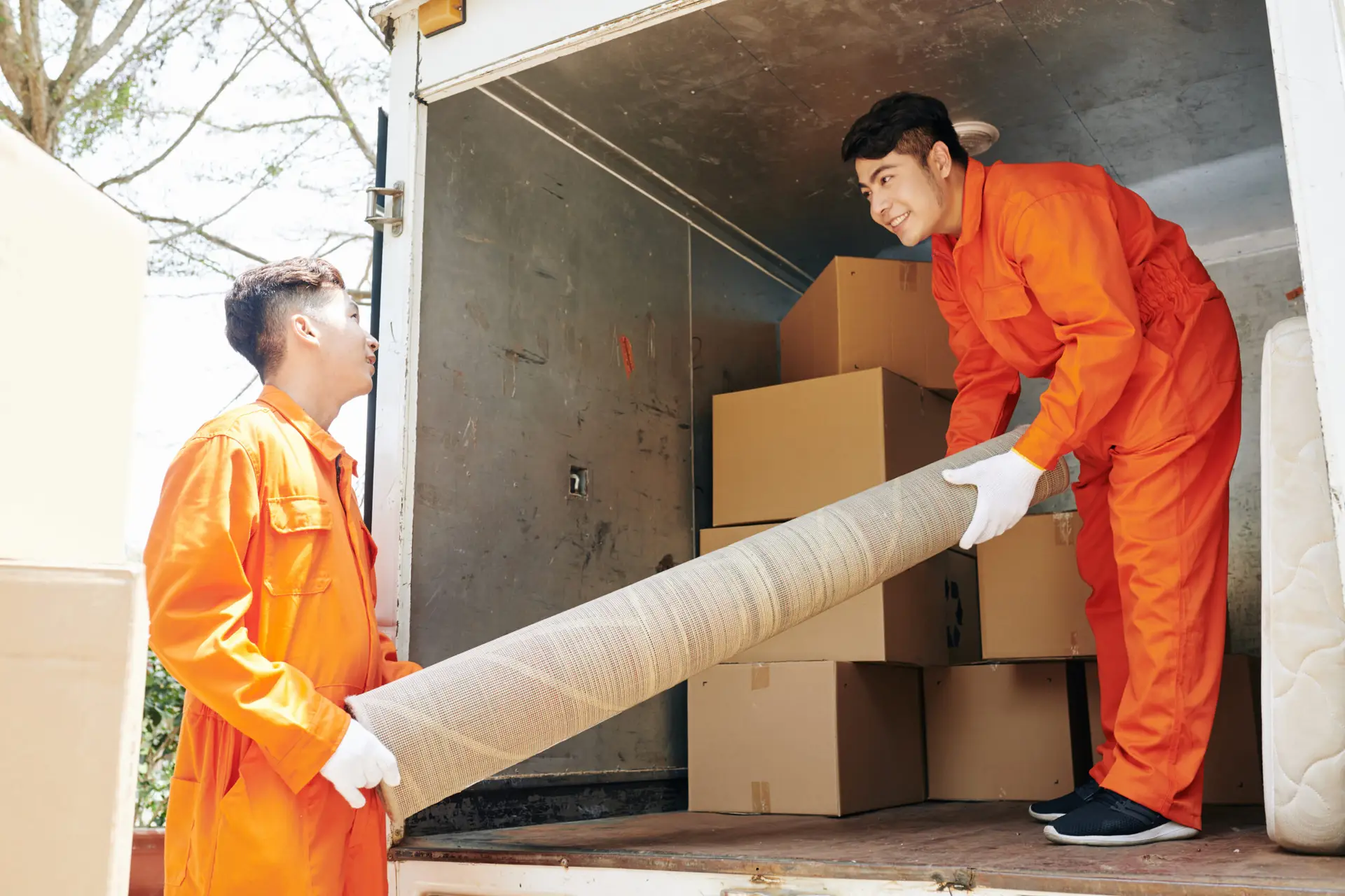 An Urgent Pro house removalists provider in Perth loading wrapped furniture and boxes into a removal truck outside a residential home, with professional equipment visible in a realistic local service setting