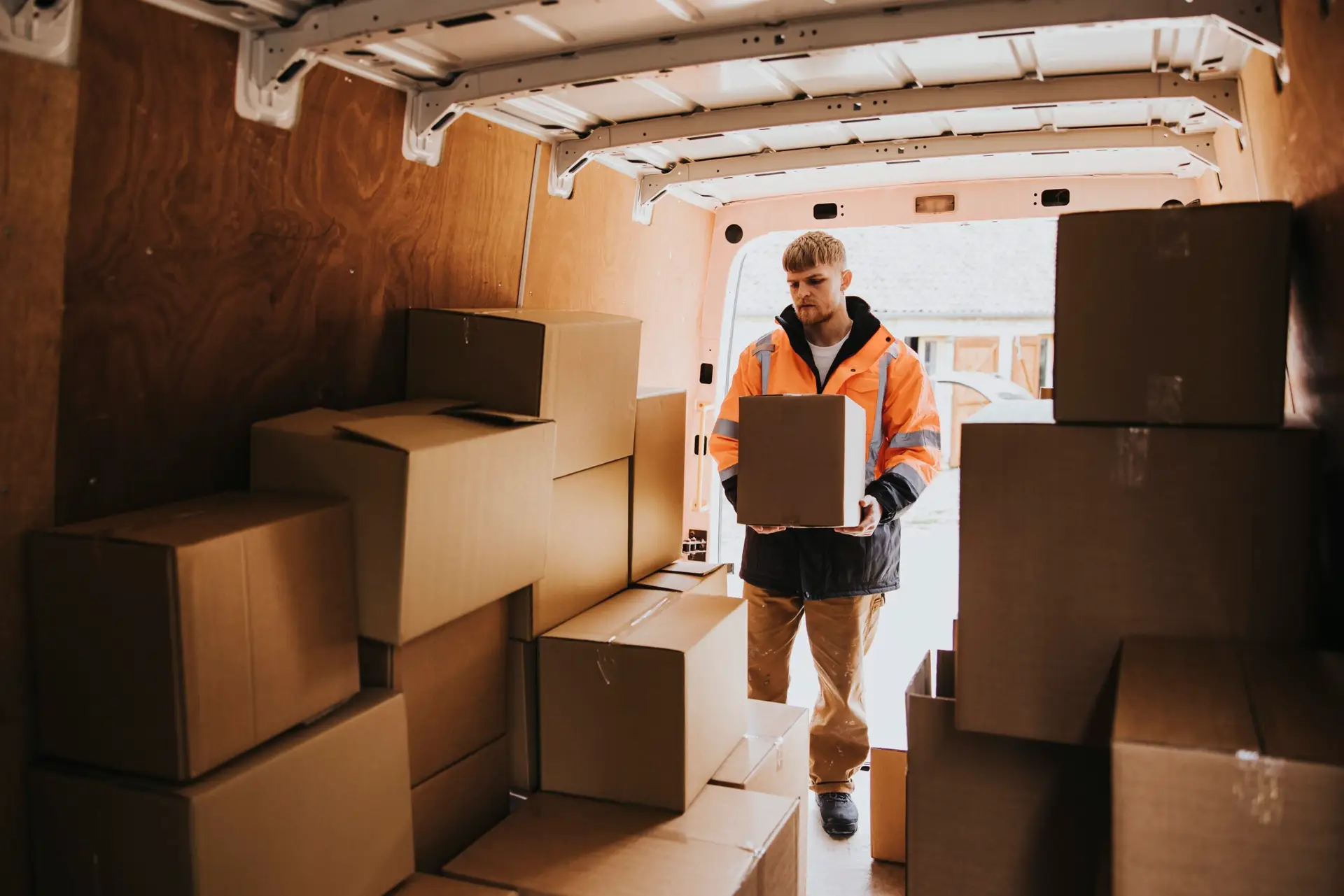 An Urgent Pro house removalists provider in Perth standing beside a fully loaded removal truck parked outside a home ready to depart, with professional equipment visible in a realistic local service setting