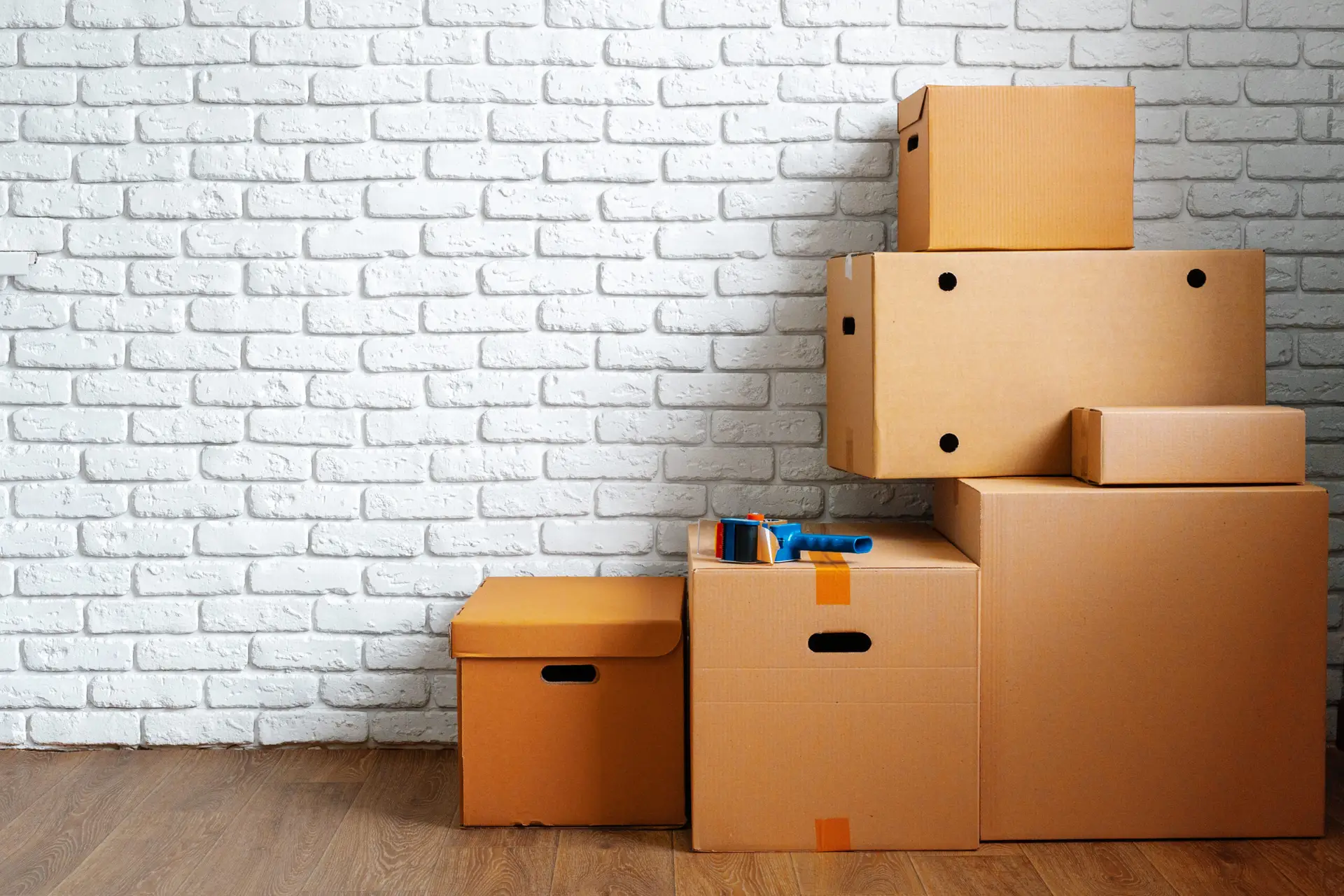 An Urgent Pro house removalists provider in Sydney carrying furniture items into a new home through the front door during the delivery stage, with professional equipment visible in a realistic local service setting