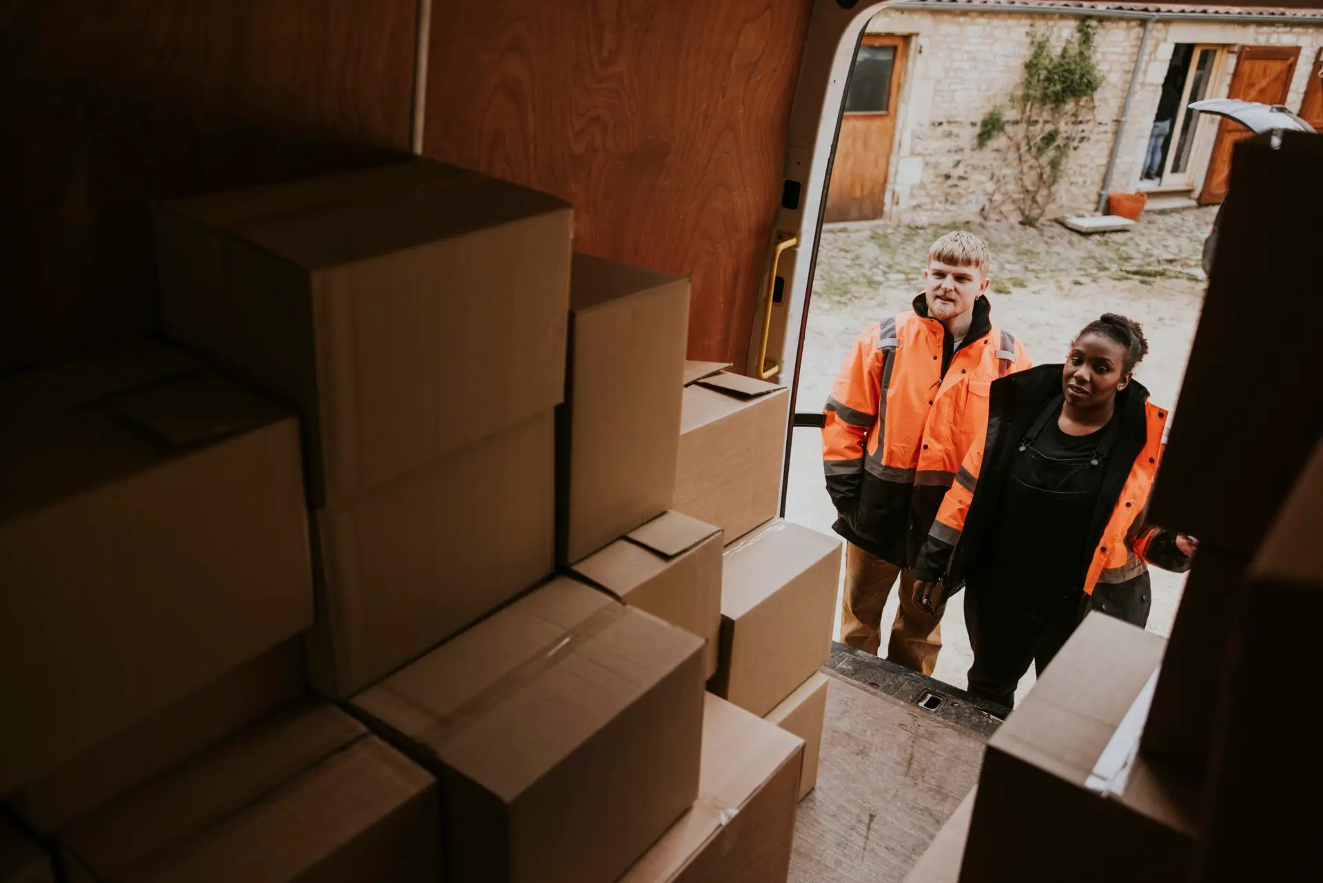 An Urgent Pro house removalists provider in Sydney loading wrapped furniture and boxes into a removal truck outside a residential home, with professional equipment visible in a realistic local service setting