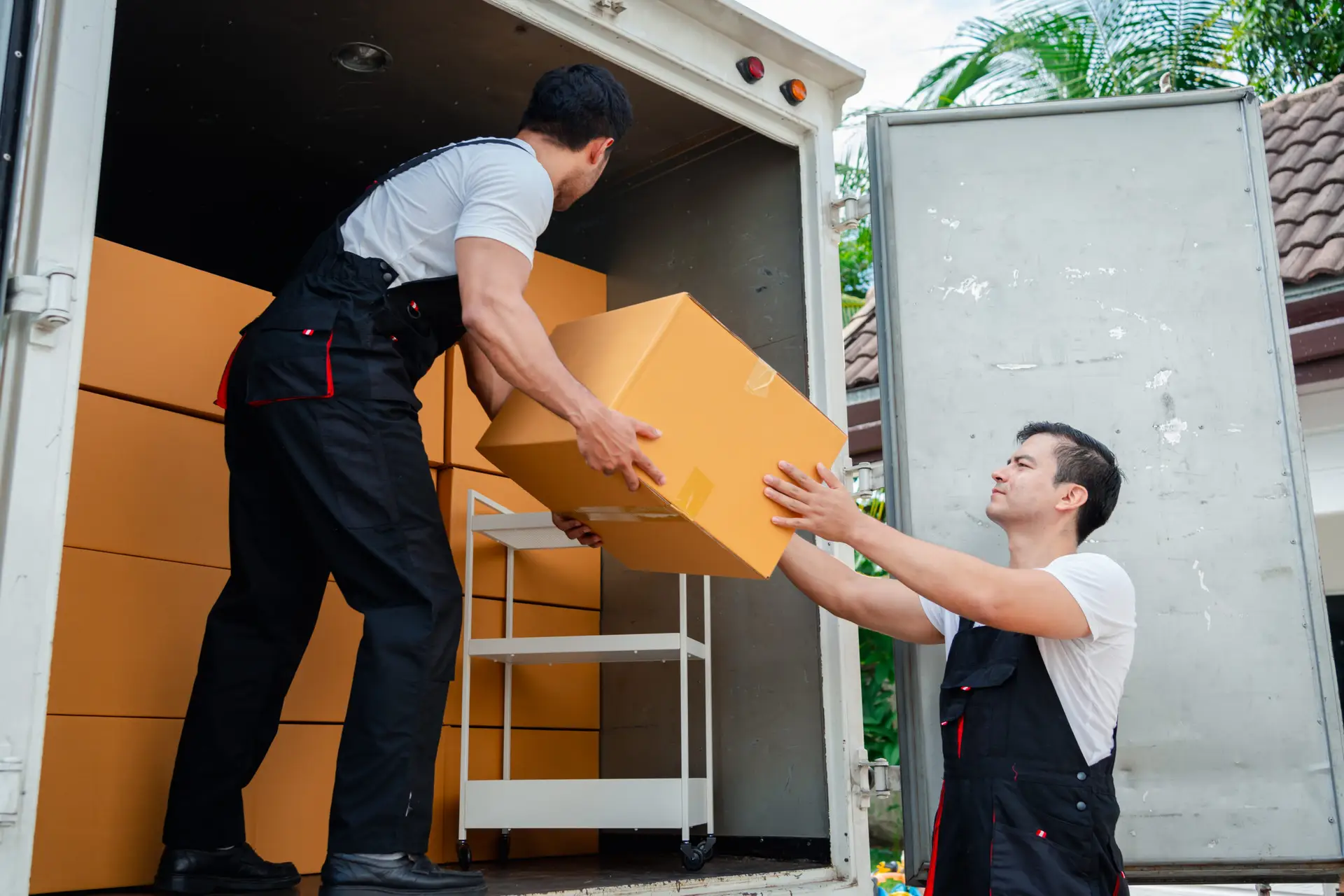An Urgent Pro house removalists provider in Sydney standing beside a fully loaded removal truck parked outside a home ready to depart, with professional equipment visible in a realistic local service setting