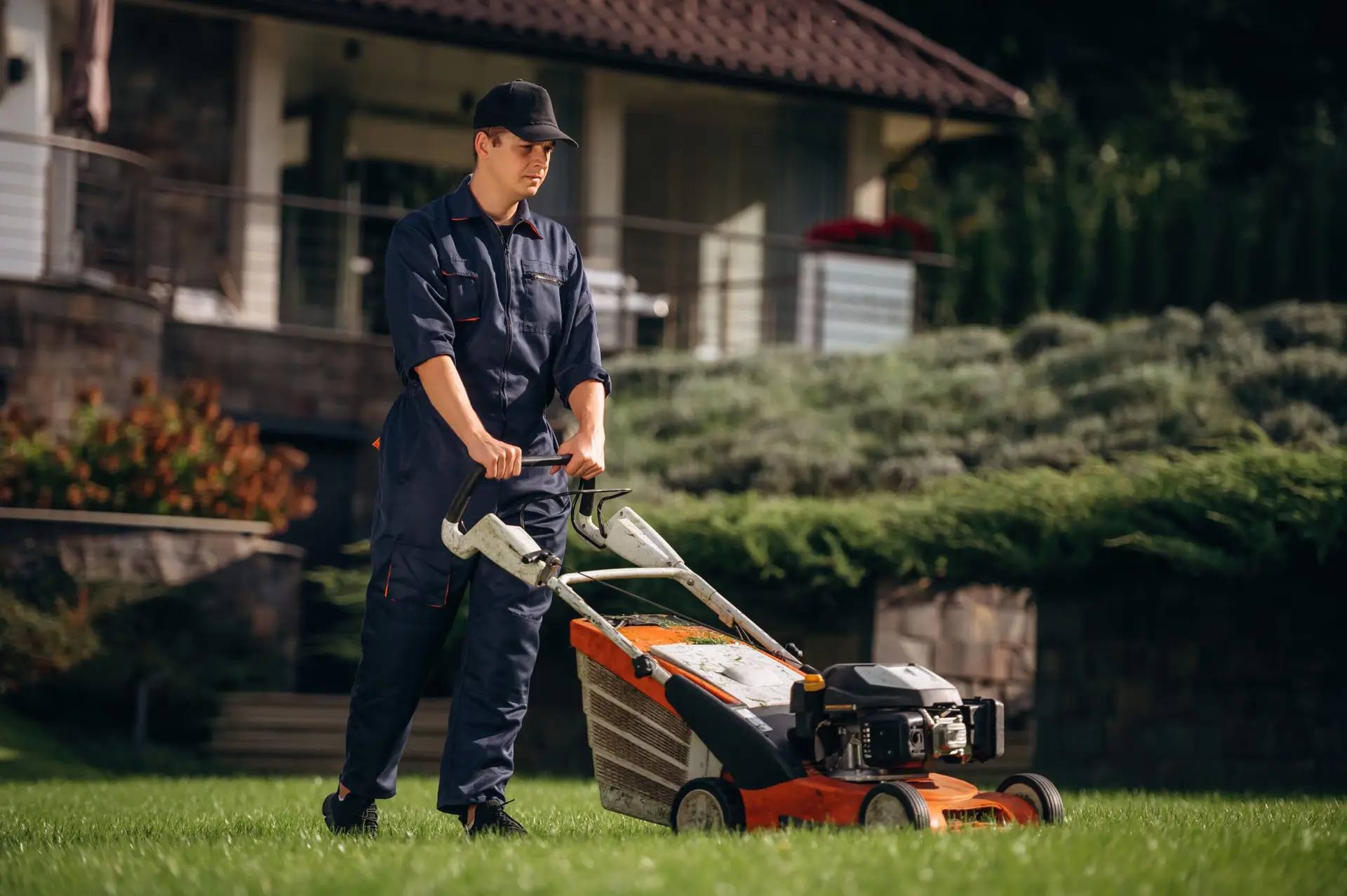 An Urgent Pro lawn mowing provider in Gold Coast operating a professional petrol mower across a residential backyard leaving clean mowing rows, with professional equipment visible in a realistic local service setting