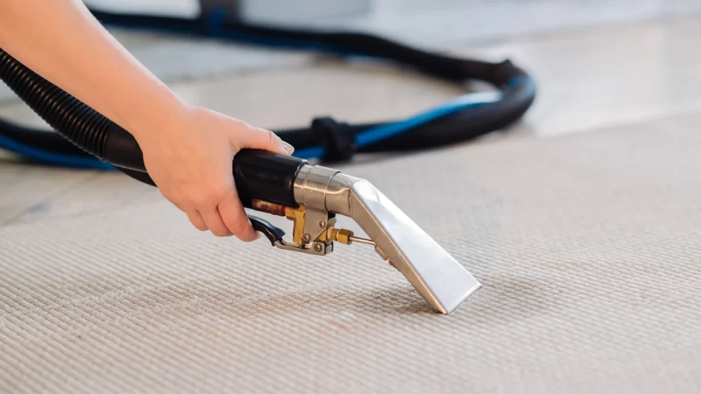 Professional carpet cleaning wand extracting water during a hot water extraction clean