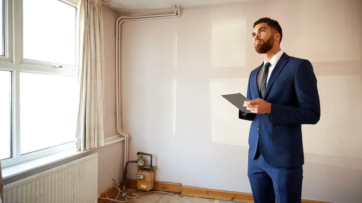 Property manager checking an empty room as part of a tenant changeover cleaning schedule