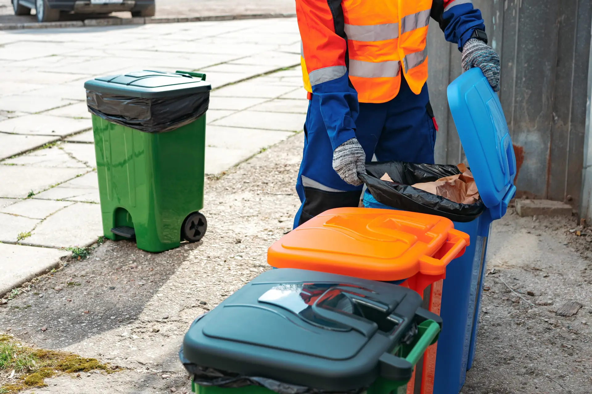 An Urgent Pro rubbish removal provider in Brisbane collecting pruned branches, grass clippings and garden debris into the truck for green waste disposal, with professional equipment visible in a realistic local service setting