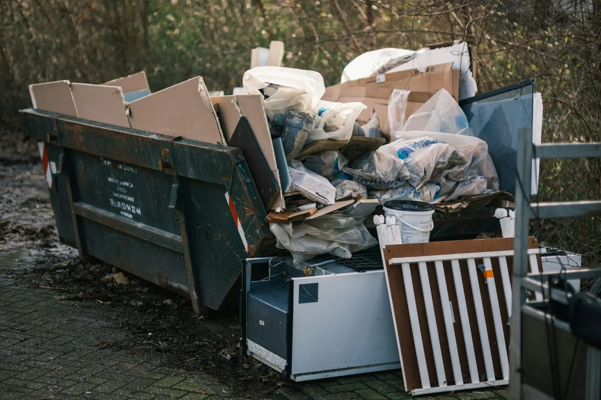 An Urgent Pro rubbish removal provider in Gold Coast removing an old sofa, armchair and table from a property for disposal and responsible recycling, with professional equipment visible in a realistic local service setting