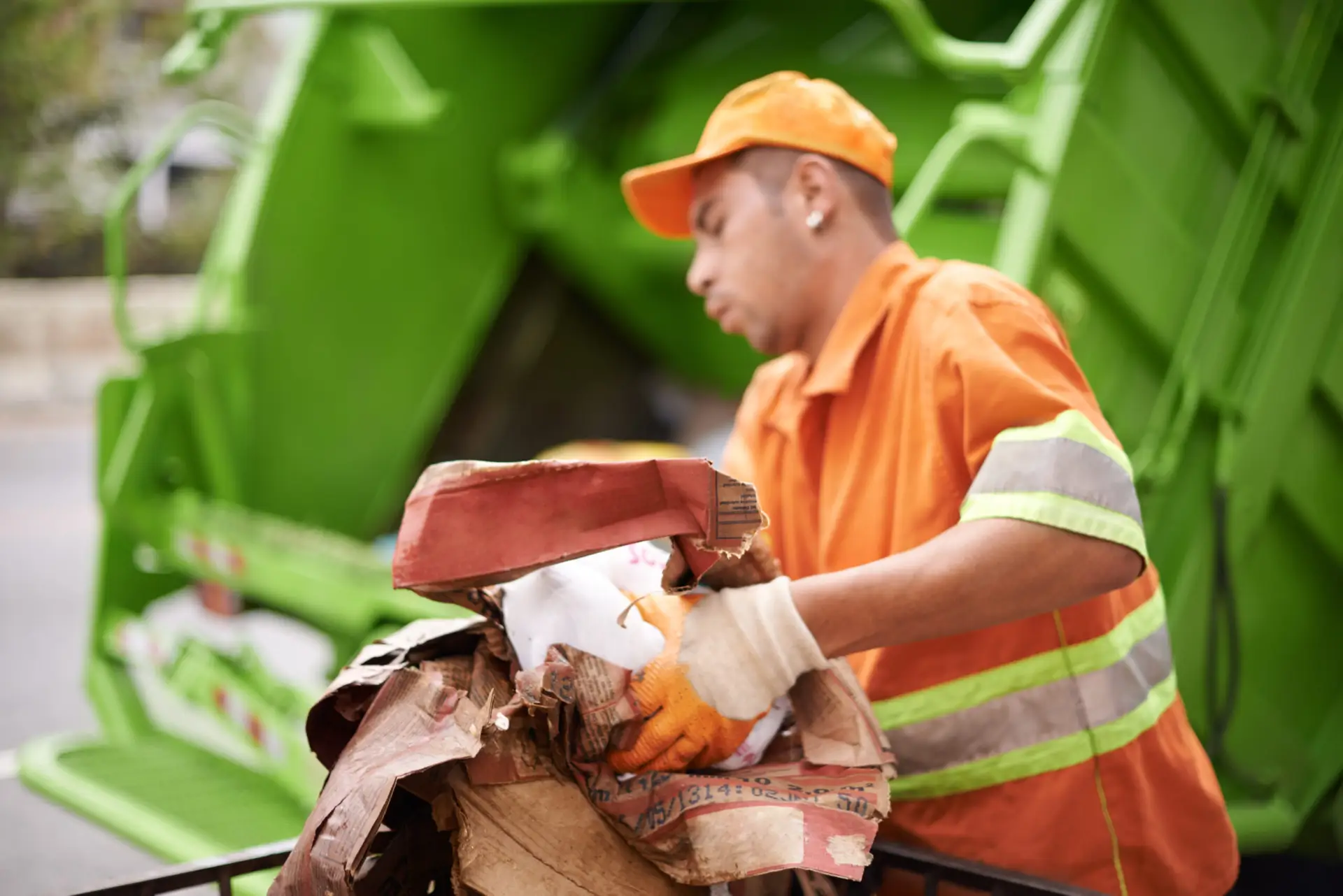 An Urgent Pro rubbish removal provider in Perth loading household junk and garden waste onto a rubbish removal truck outside a residential property, with professional equipment visible in a realistic local service setting