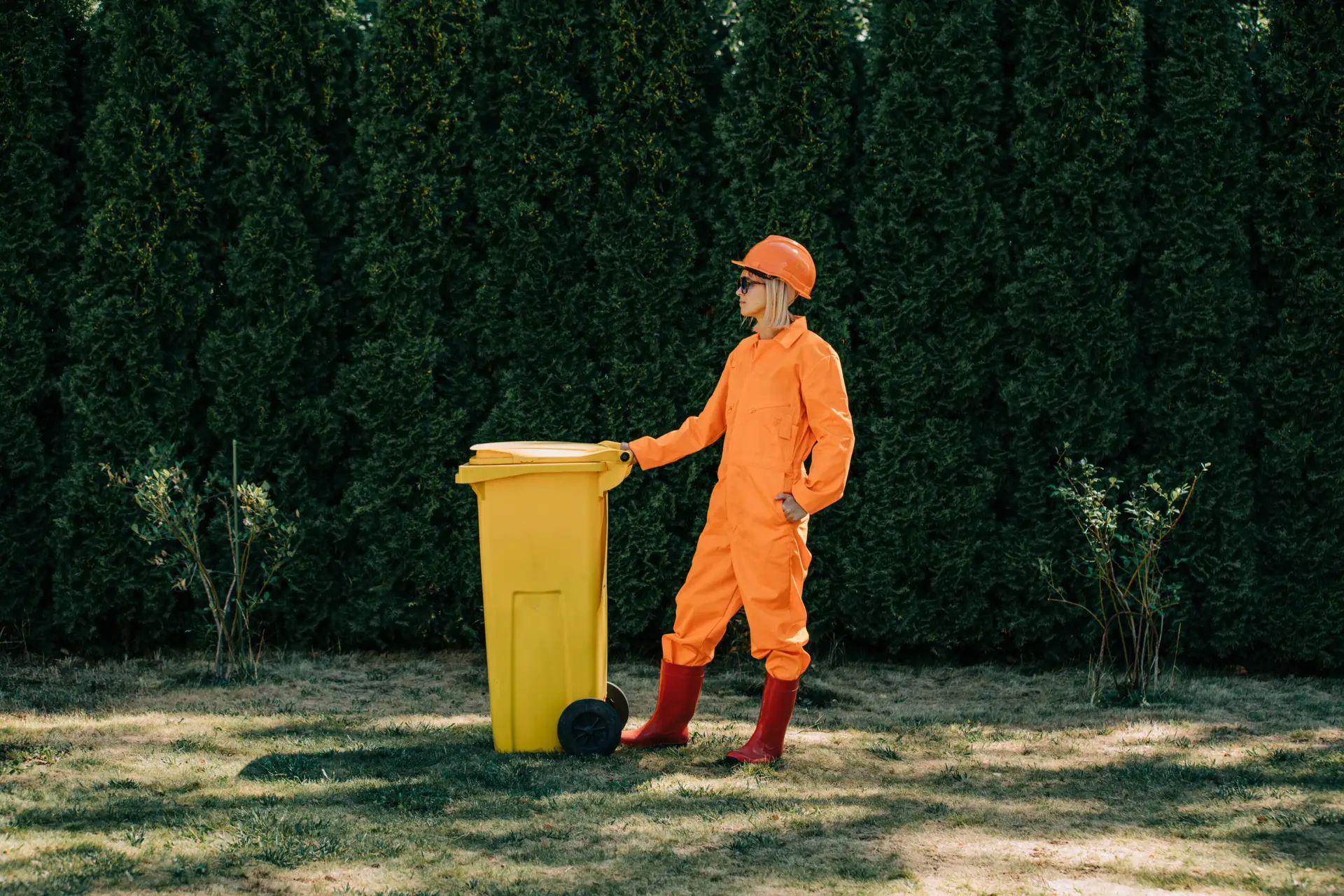 An Urgent Pro rubbish removal provider in Sydney collecting pruned branches, grass clippings and garden debris into the truck for green waste disposal, with professional equipment visible in a realistic local service setting