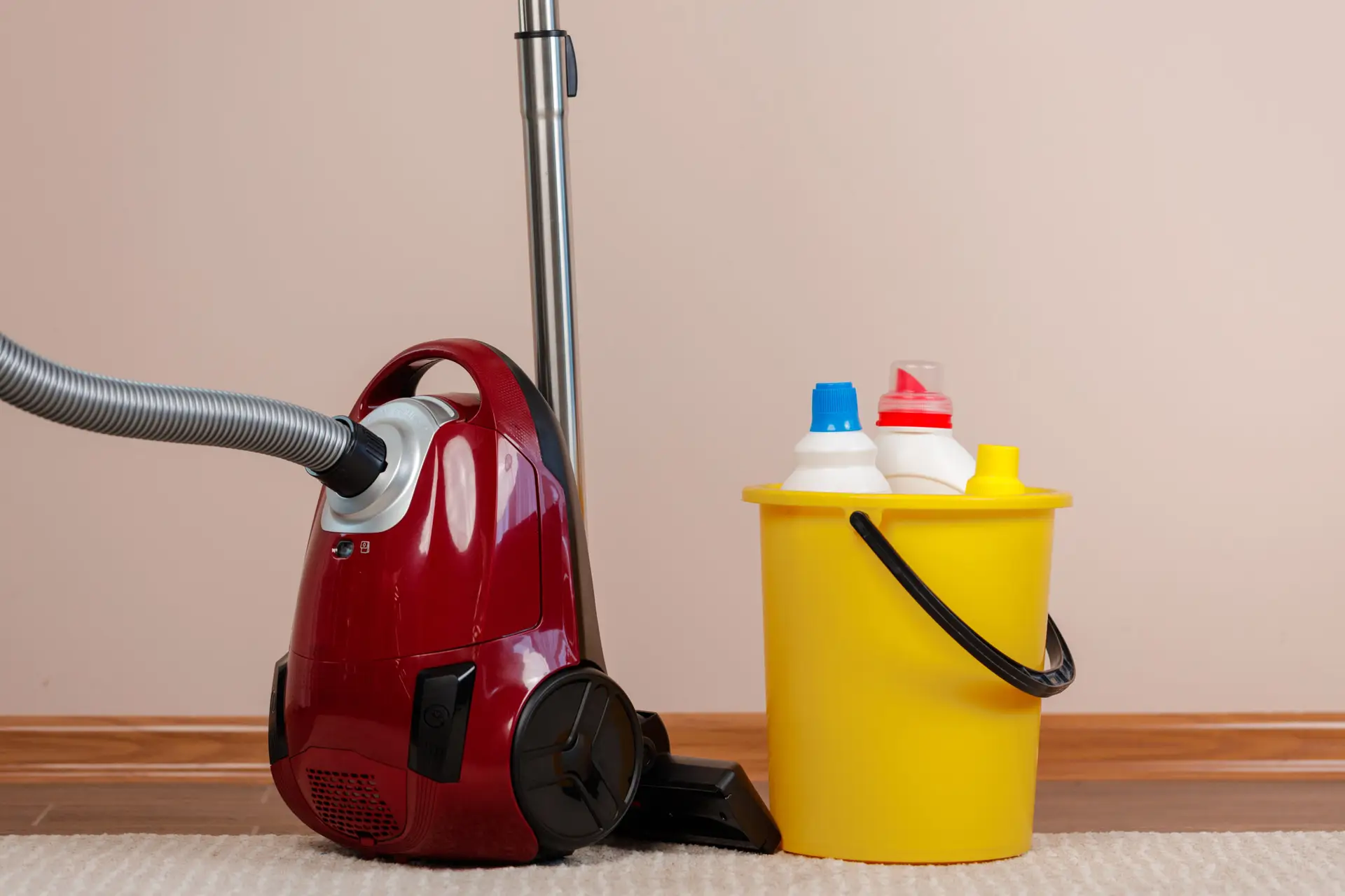 A complete professional vacate cleaning kit arranged on the floor of a Perth rental property — including a commercial vacuum, flat mop, steam cleaner, oven cleaner, grout spray, glass cleaner, antibacterial surface spray, rubber gloves and a full set of microfibre cloths in different colours